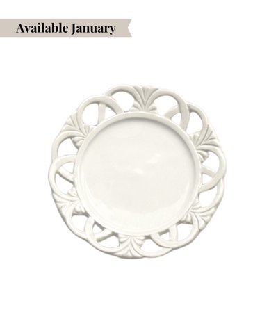 Decorative white bread plate with intricate rim pattern