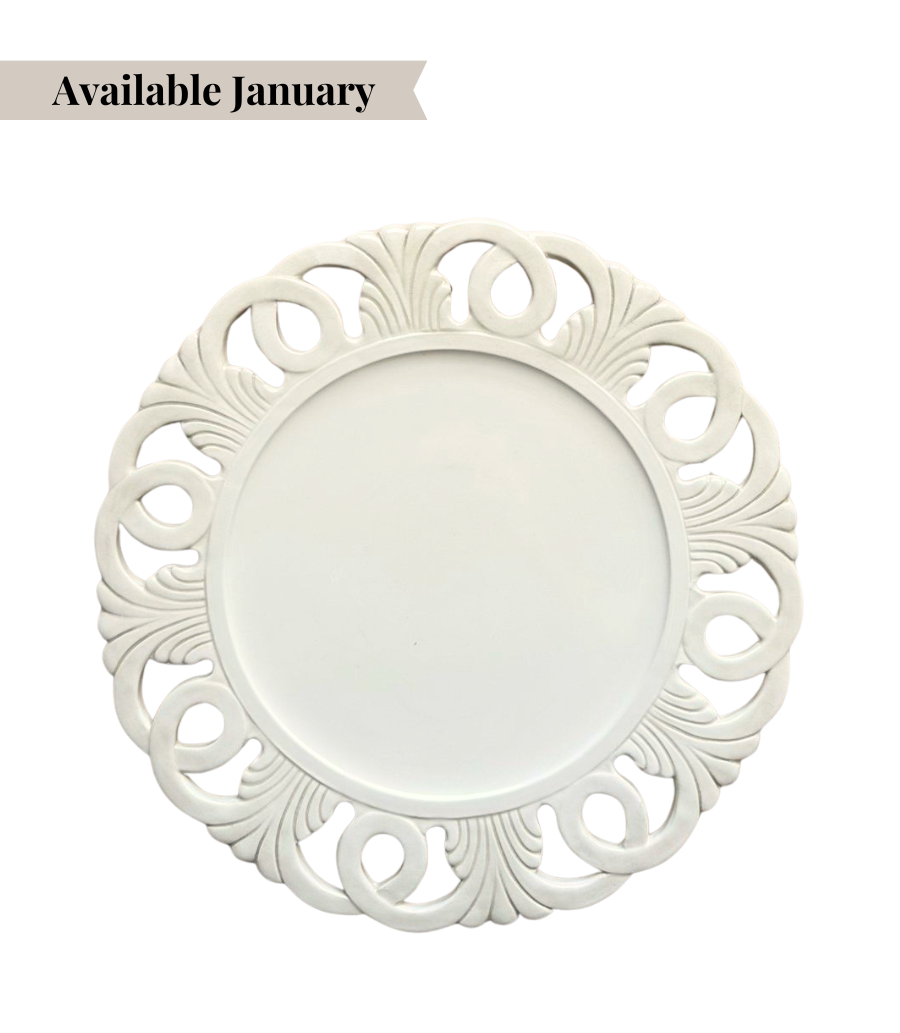 Decorative white charger plate with intricate rim pattern