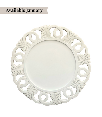 Decorative white charger plate with intricate rim pattern