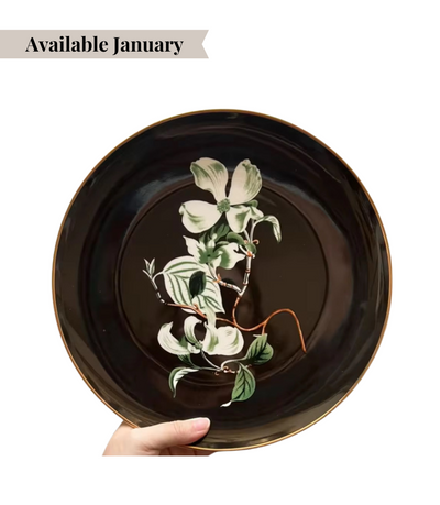 black dinner plate featuring a high contrast floral design