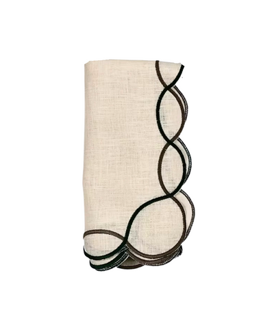 cream linen napkin with black trim scalloped edges