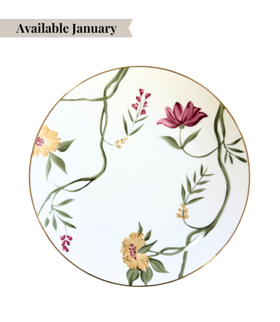 white porcelain plate with floral design and thing gold trim