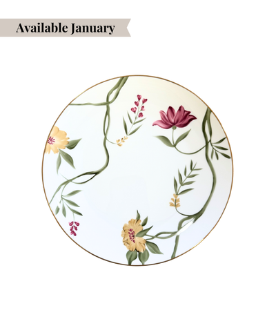 white porcelain dinner plate with floral design and gold trim