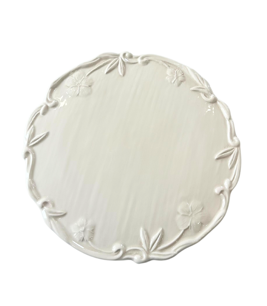ivory charger plate with embossed floral rim