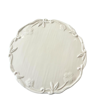 ivory charger plate with embossed floral rim