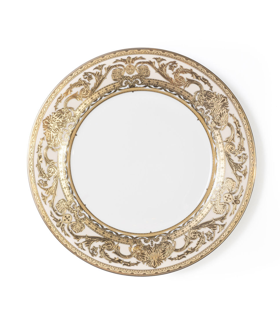 white charger plate with intricate gold rim detailing 