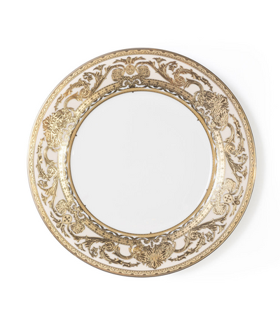 white charger plate with intricate gold rim detailing 