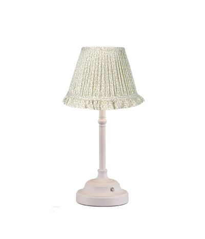white base table lamp with green leaf pattern