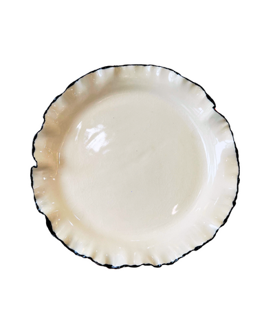 cream ceramic dinner plate with black trim ruffled edge 