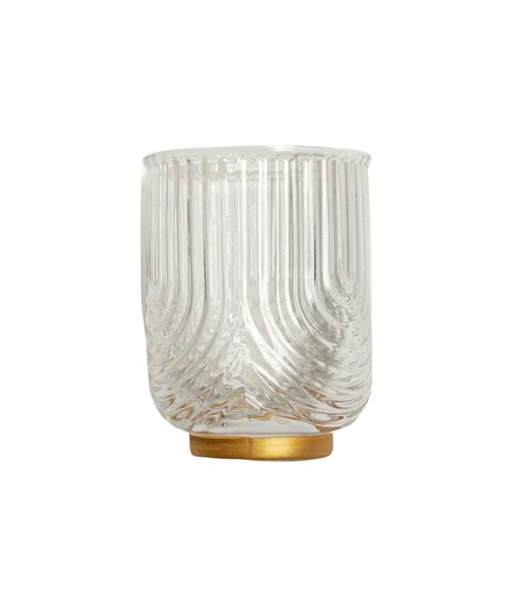 clear water tumbler with textured surface and brushed gold base