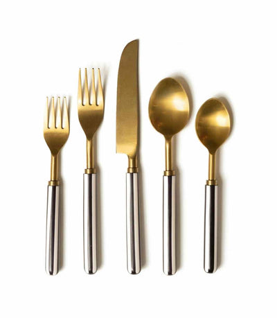 gold cutlery with a striped black and white handle