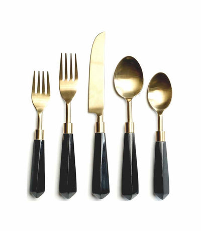 gold cutlery with a black acrylic handle