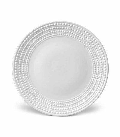 white porcelain charger plate with rows of raised pearls around the rim